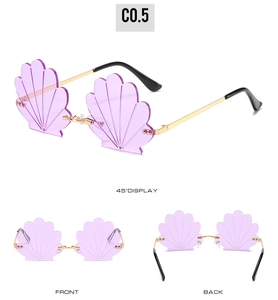 Detail view of purple shell-shaped rimless sunglasses with gold metal temples and frames