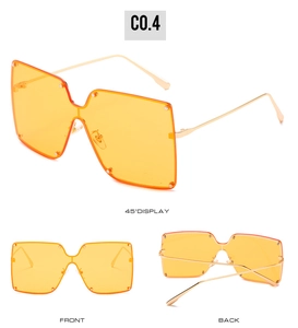 Detailed views of oversized square rimless sunglasses with orange lenses and gold studs