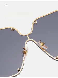 Close-up of comfortable silicone nose pads and gold metal frame of oversized sunglasses