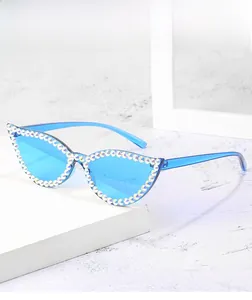 Detailed view of blue cat-eye sunglasses with hand-set iridescent AB rhinestones