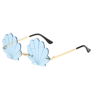 Creative shell shaped sunglasses with blue lenses and gold metal frames for beach style