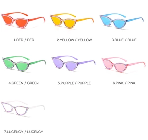 Multiple colors of cat-eye rhinestone sunglasses shown in a flat lay arrangement