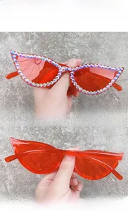Close-up of red cat eye sunglasses with handcrafted sparkling colorful rhinestones