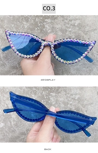 Detail view of cat eye sunglasses with hand-set AB rhinestones and blue frames