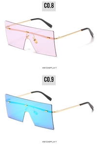 Detail view of pink and blue rimless oversized square sunglasses with gold temples