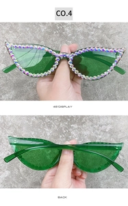 Detailed view of green cat eye sunglasses with hand-set colorful rhinestones