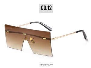 Detail view of oversized square rimless sunglasses with gradient lenses and gold metal temples