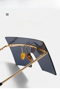 Detail of gold metal frame square sunglasses with lightweight and flexible hinges