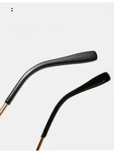 Detailed view of square sunglasses featuring ergonomic gold and black curved mirror legs