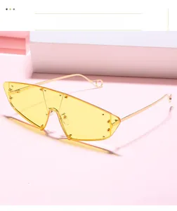 Detail of amber oversized shield sunglasses with gold rivets and metallic temples