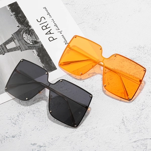 Chic oversized rimless sunglasses with metal rivets in black and bright orange colors