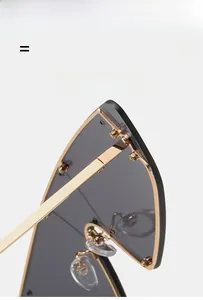 Detail view of golden metal frame with transparent nose pads and dark semi-rimless lenses