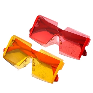 Oversized rimless shield sunglasses in vibrant red and yellow colors for fashion street style