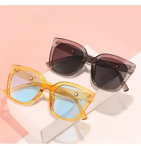 Detail of square oversized sunglasses with metallic dots on amber and grey frames