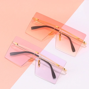 Fashionable oversized rimless sunglasses with gradient orange and purple geometric lenses