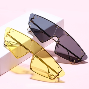 Modern cat-eye oversized sunglasses with rivet decorations on yellow and grey lenses