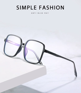 Detail shot of anti-blue light glasses lens showing violet reflection on geometric stand