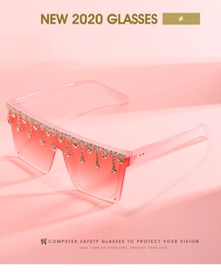 Detail of pink fashion sunglasses featuring sparkling rhinestone fringe and gradient lenses