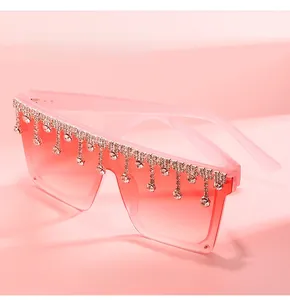 Detail of pink gradient sunglasses with sparkling rhinestone tassels and oversized frame