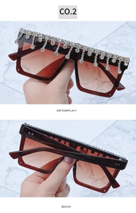 Detail view of oversized square sunglasses with sparkling rhinestone fringe and gradient lenses