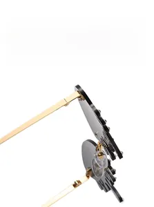 Close-up of gold metal frame sunglasses featuring crystal drop details and soft nose pads