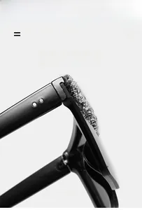 Detail of square oversized sunglasses showing rhinestone encrusted frame and metal rivets