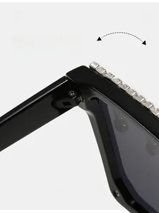 Macro detail of durable metal hinges and rhinestone accents on oversized square sunglasses