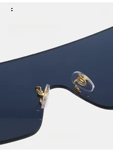 Detail of comfortable silicone nose pads and gold metal bridge on rimless sunglasses