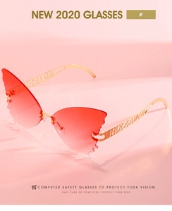 Close-up of red gradient butterfly wing lenses and golden hollow metal temples