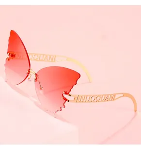 Detail of red gradient butterfly lenses with hollow metal temples on pink display