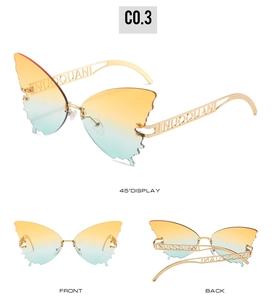 Macro detail of rimless butterfly sunglasses with yellow-blue gradient and gold metal frame
