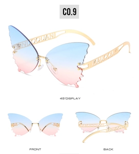 Macro detail of butterfly sunglasses with blue-pink gradient lenses and gold frames
