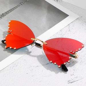 Fashionable butterfly shaped rimless sunglasses with red lenses and sparkling rhinestones