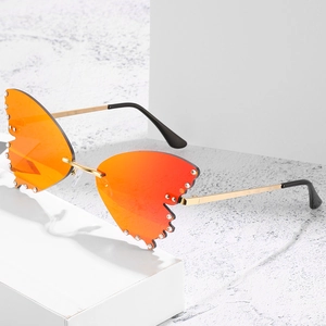 Fashion butterfly rimless sunglasses with orange gradient lenses and rhinestone accents