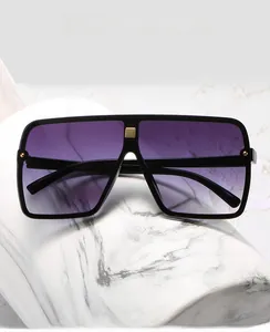 Detail of square oversized sunglasses with purple gradient lenses and gold rivets