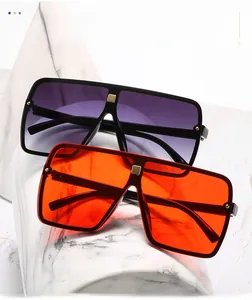 Detail of oversized square sunglasses with gradient lenses and gold rivets decoration