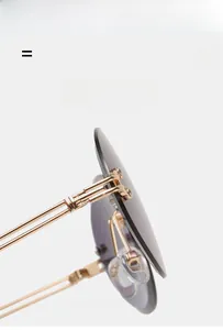 Detail of metal hinge and purple gradient lens on lightweight oval sunglasses