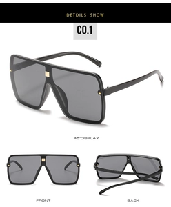 Detail view of large square oversized sunglasses with gold rivets and flat top frame