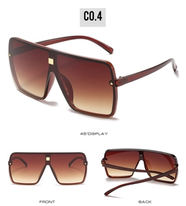 Brown gradient lenses on oversized square sunglasses with gold metal rivet accents