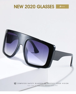 Close-up of flat-top oversized black sunglasses with purple gradient lenses on stand