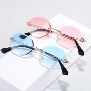 Retro rimless oval sunglasses set with pink and blue gradient lenses and gold metal temples