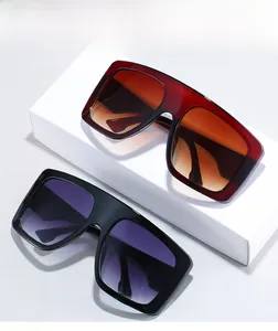 Texture material detail of oversized fashion sunglasses with gradient lenses in red and black