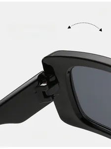 Detail of durable texture hinges and glossy black frame on trendy large frame sunglasses