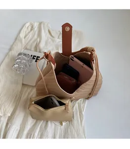 Detail of beige woven tote bag interior showing large capacity for tablet and wallet