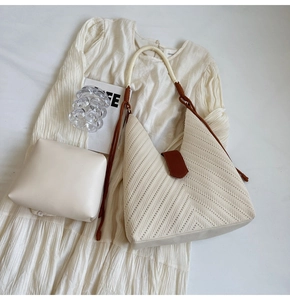 Detail of woven tote bag with beige canvas texture and matching leather inner pouch