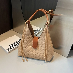 Knit tote bag with chevron pattern and brown rope handles in a modern minimalist setting