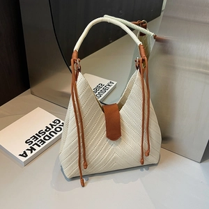 Large cream woven tote bag with herringbone pattern and brown leather magnetic clasp