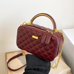 Quilted burgundy crossbody bag with golden top handle and chain strap for women