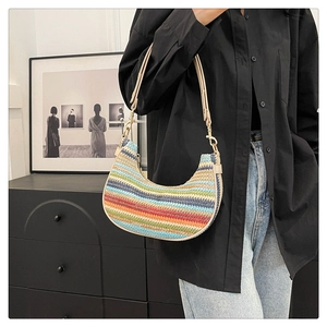 Detail of colorful striped woven hobo bag with beige leather strap and gold buckle