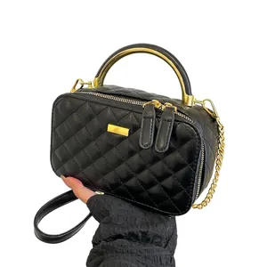 Quilted crossbody bag in black faux leather with gold circular handle and chain strap